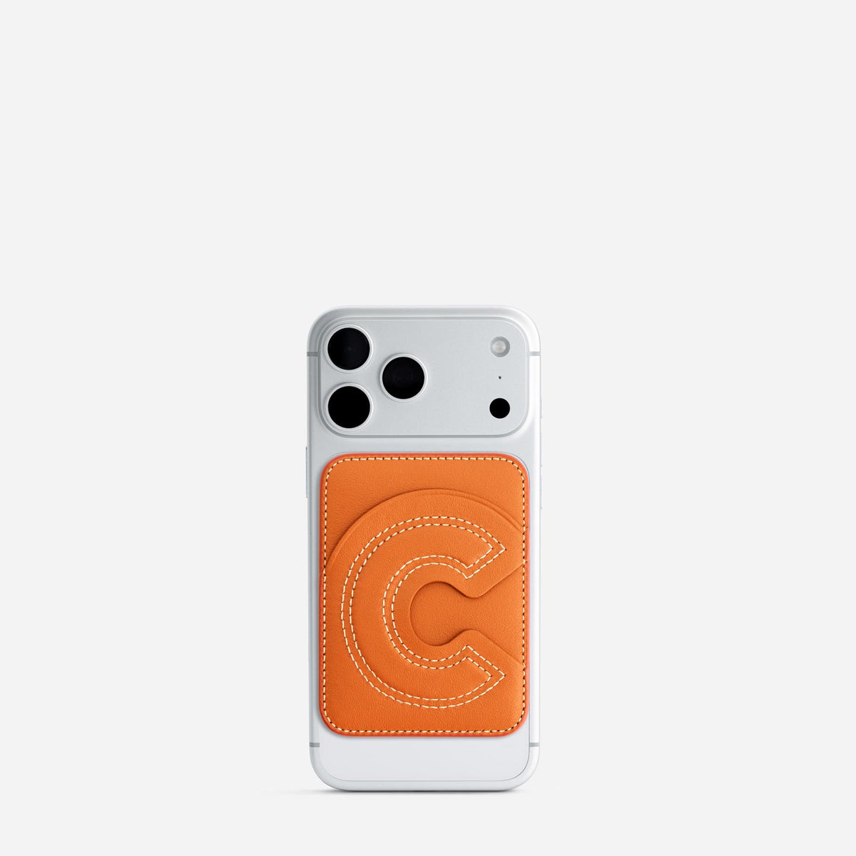 MagSafe cardholder in Orange, initial C, on phone