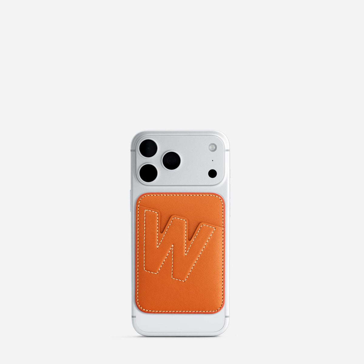 MagSafe cardholder in Orange, initial W, on phone